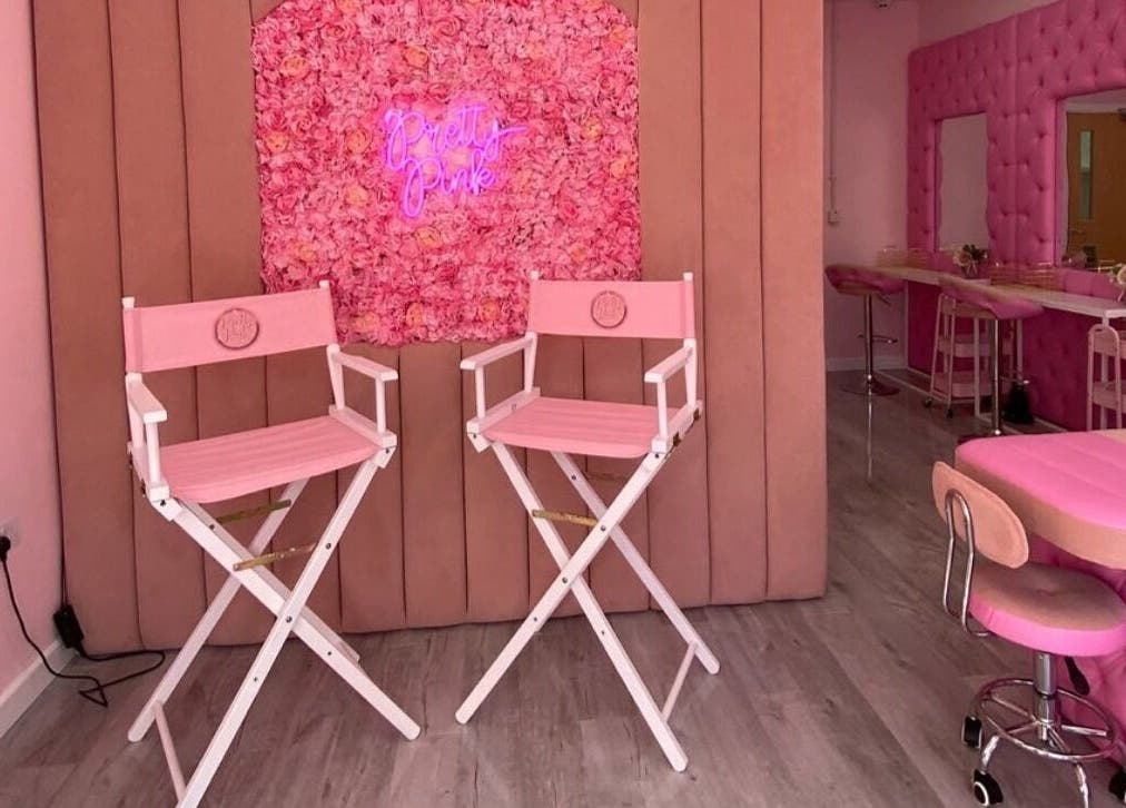 Stylish pink interior of Liberty Autumn Aesthetics, Southampton, England, GB, with floral decor and beauty chairs.