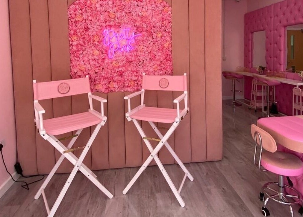 Stylish pink interior of Liberty Autumn Aesthetics, Southampton, England, GB, with floral decor and beauty chairs.