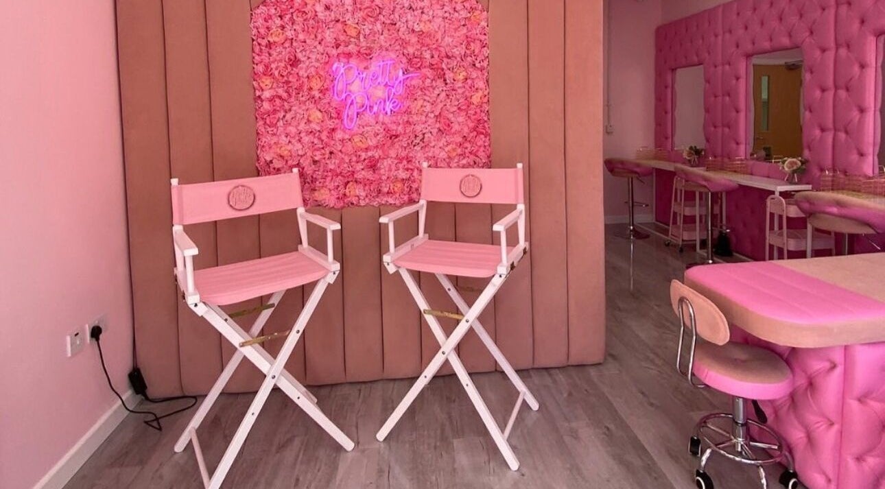 Stylish pink interior of Liberty Autumn Aesthetics, Southampton, England, GB, with floral decor and beauty chairs.