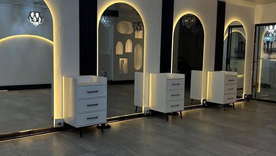 Luxurious interior of Sallybraids in Toronto, Ontario, CA featuring elegant backlit salon mirrors.