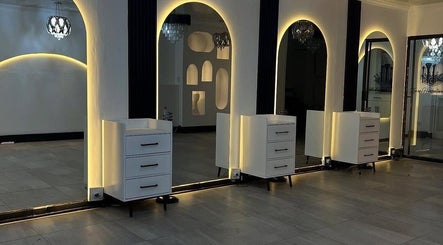 Luxurious interior of Sallybraids in Toronto, Ontario, CA featuring elegant backlit salon mirrors.
