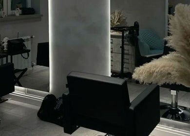 Modern salon seating area at Sallybraids in Toronto, Ontario, CA, featuring sleek chairs and stylish decor.