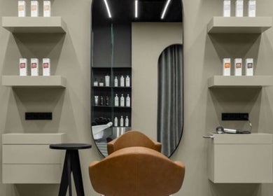 Modern salon chair and shelves at Sallybraids, Toronto, Ontario, CA, offering premium hair care services.