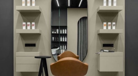 Modern salon chair and shelves at Sallybraids, Toronto, Ontario, CA, offering premium hair care services.