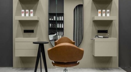 Stylish salon chair and shelves at Sallybraids in Toronto, Ontario, CA with hair products and mirror.