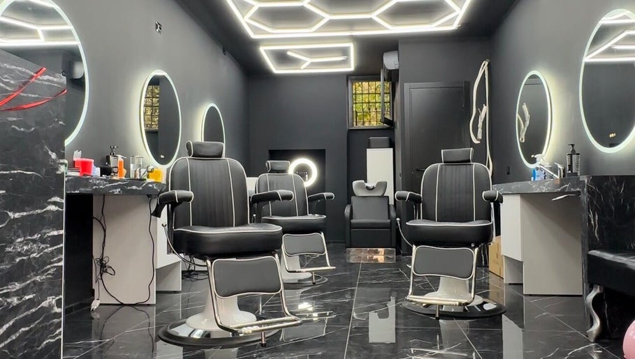 Stylish interior of Euro Cut Barber in Roma, Lazio, IT with modern barber chairs and illuminated mirrors.
