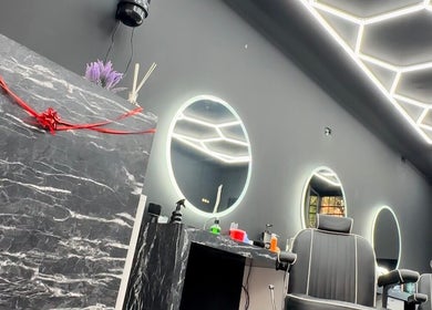 Sleek interior of Euro cut Barber in Roma, Lazio, IT featuring modern mirrors and stylish chairs.