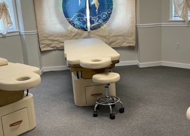Calm therapy room at Wu Therapeutic Massage and Head Spa, Fairfax, Virginia, US with massage tables and stools.