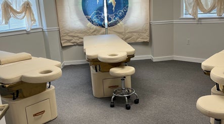 Calm therapy room at Wu Therapeutic Massage and Head Spa, Fairfax, Virginia, US with massage tables and stools.