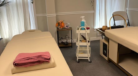 Relaxing massage room at Wu Therapeutic Massage and Head Spa, Fairfax, Virginia, US, featuring massage tables and decor.