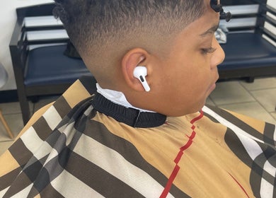 Young boy with a fresh fade at Kecho’s Barbershop, Dallas, Texas, US.