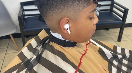 Young boy with a fresh fade at Kecho’s Barbershop, Dallas, Texas, US.
