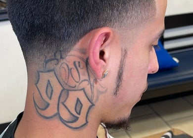 Close-up of a stylish fade haircut with neck tattoo at Kecho’s Barbershop, Dallas, Texas, US.