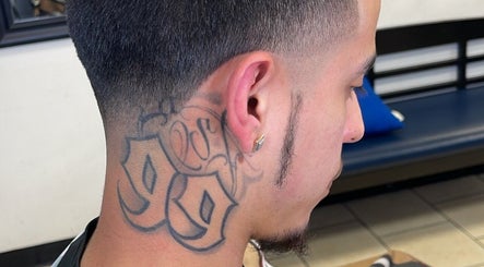 Close-up of a stylish fade haircut with neck tattoo at Kecho’s Barbershop, Dallas, Texas, US.