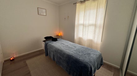 Tranquil massage room at Azur Coast Massage by Jess, O'sullivan Beach, South Australia, AU with soft lighting.