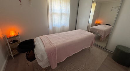 Relaxing massage room at Azur Coast Massage by Jess, O'sullivan Beach, South Australia, AU with soft lighting.