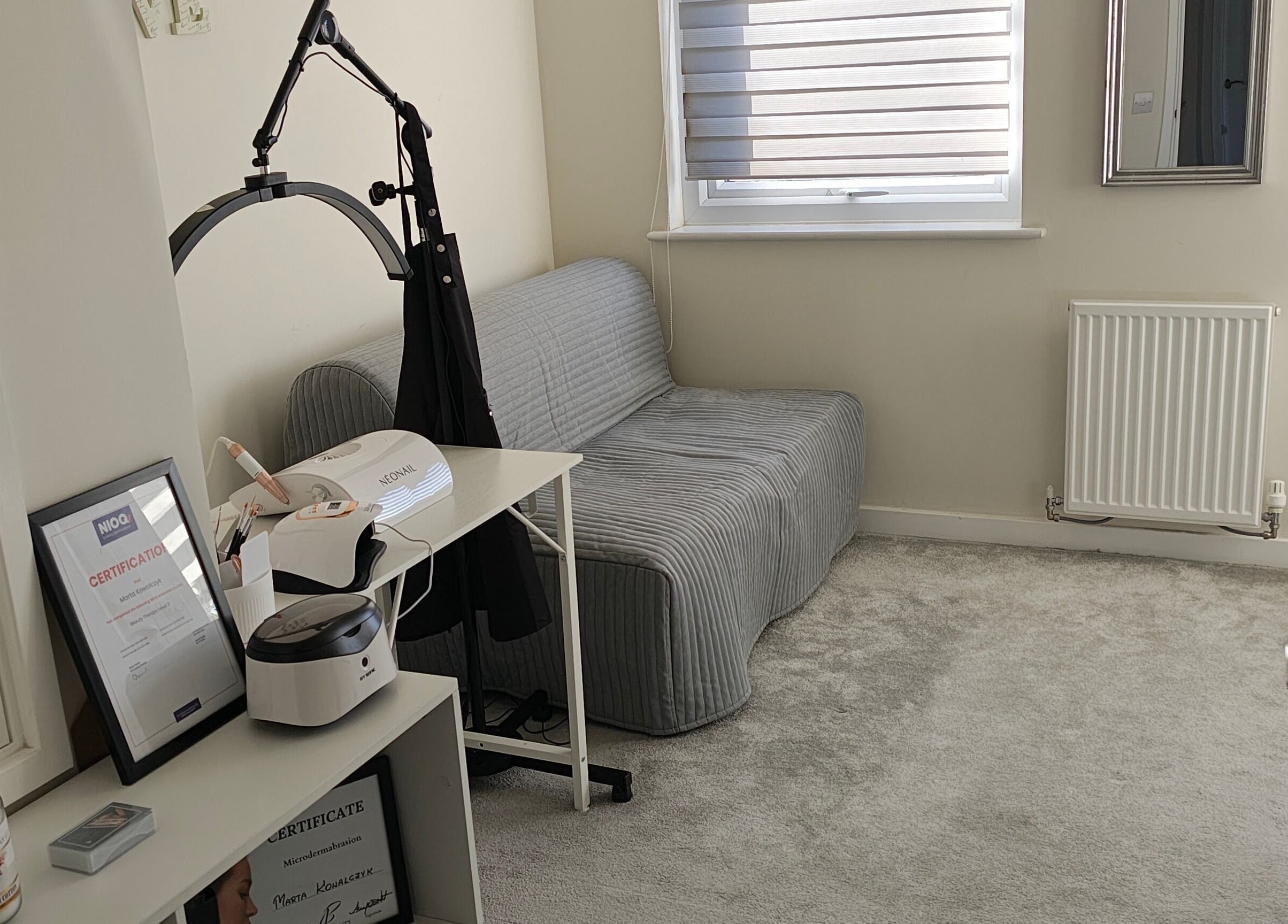 Cozy treatment room at MK Beauty, Hartlepool, England, GB with sofa and beauty equipment.
