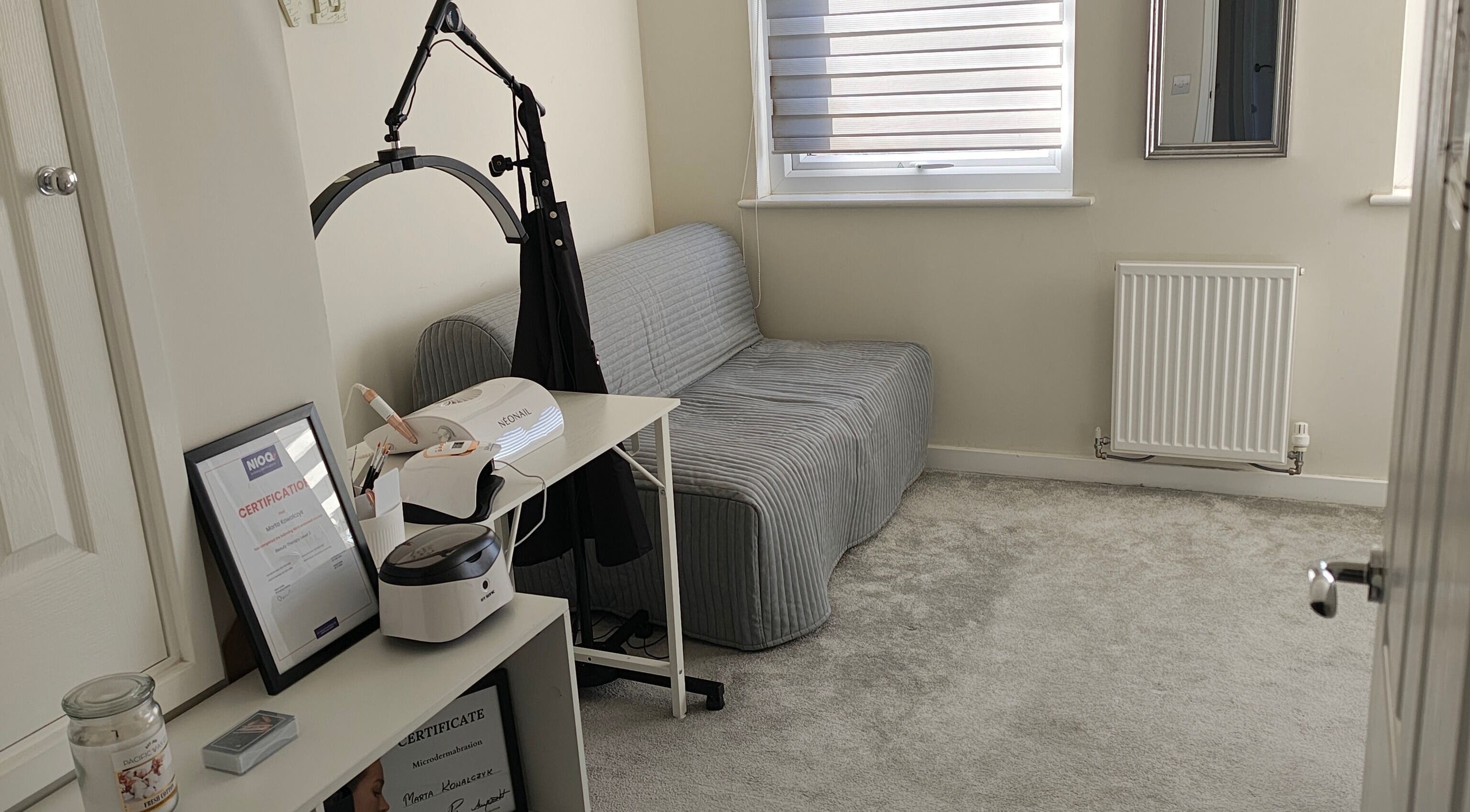 Cozy treatment room at MK Beauty, Hartlepool, England, GB with sofa and beauty equipment.