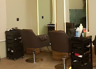 Modern salon interior at Saje Beauty Lagos, Street, Lagos, NG with chic styling chairs and mirrors.