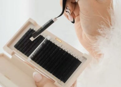 Applying high-quality lashes at Pink Boutique in Mount Nathan, Queensland, AU. Perfect for beauty enhancements.