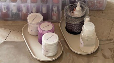 Nail care supplies at The Manicurist, Dubai, Abu Dhabi, AE showcase organized bottles and jars.