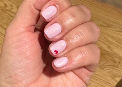 Elegant pink nails with a heart design at The Manicurist, Dubai, Abu Dhabi, AE.