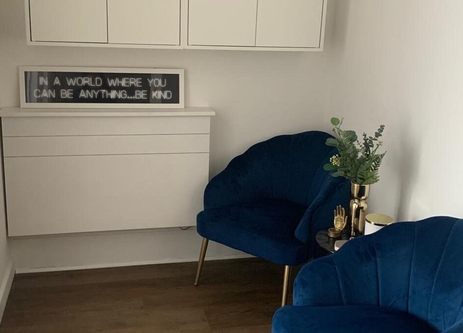 Elegant waiting area at My Face Atelier, High Wycombe, England, GB with blue chairs and decorative plants.