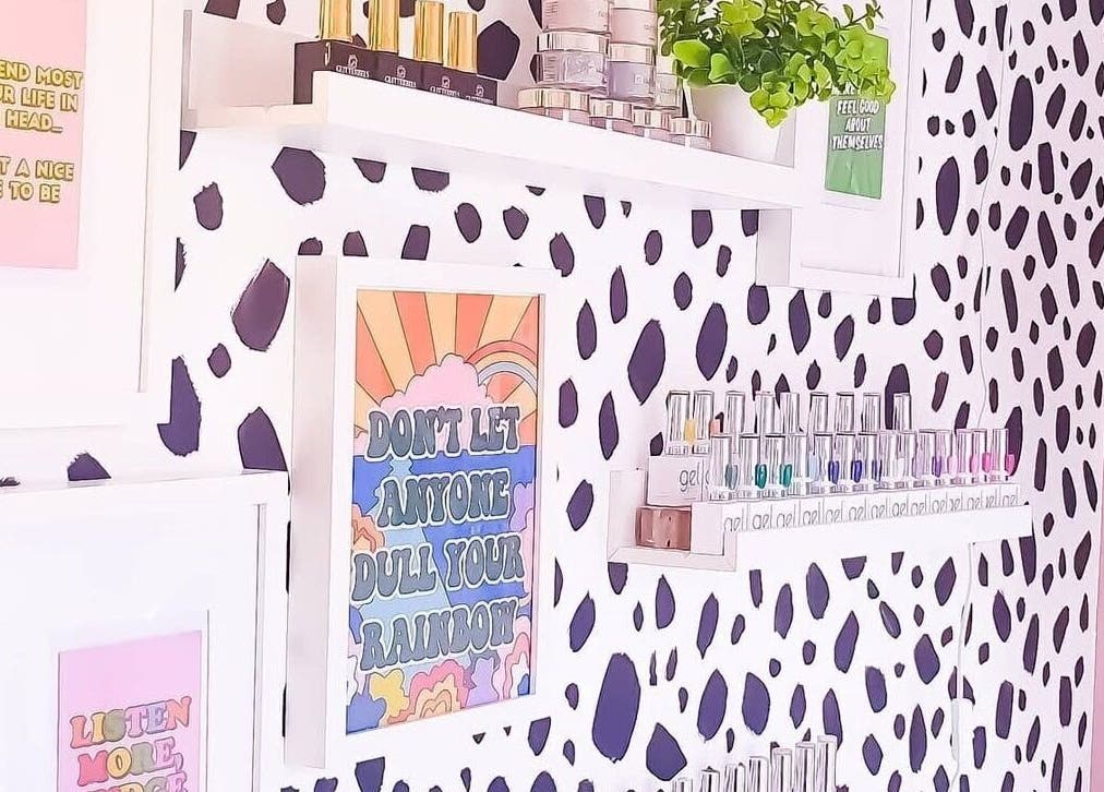 Stylish nail polish wall at Beautiques Nails, Burton Upon Trent, England, GB with quotes and decor accents.