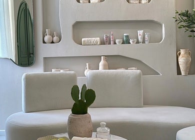 Modern minimalist decor at Zan Beauty | زان بيوتي, Riyadh, Riyadh Province, SA. Elegant seating and shelves with products.