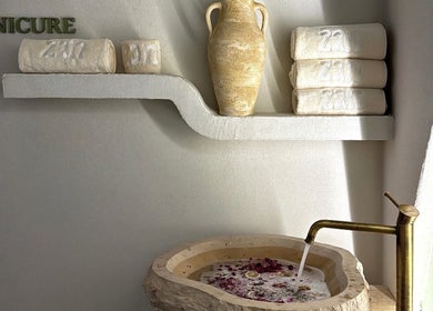 Towels and a ceramic pot at Zan Beauty | زان بيوتي, Riyadh, Riyadh Province, SA. Luxurious spa setting.