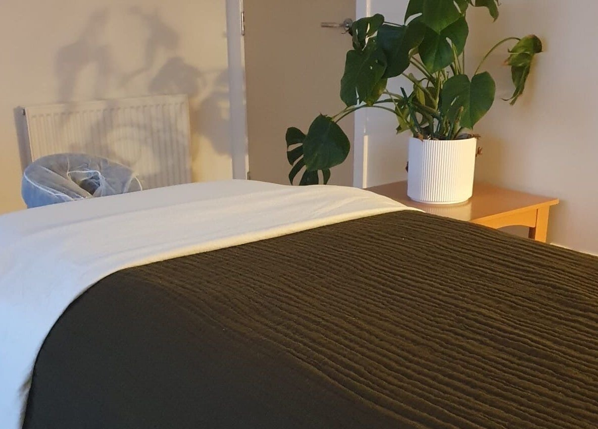 Cozy massage room at The Zen Hen, Glasgow, Scotland, GB, with a lush plant accent.