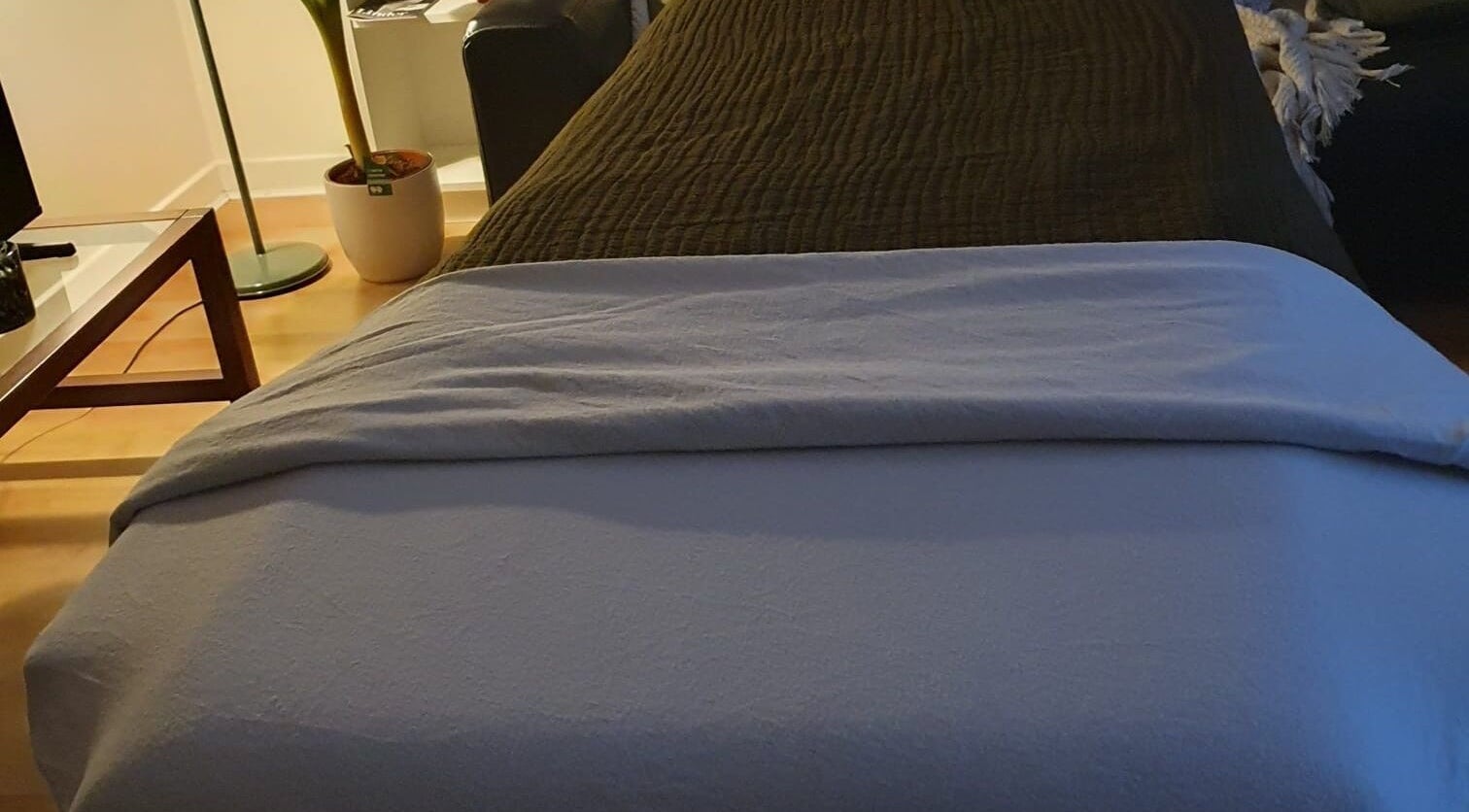 Cozy massage bed in The Zen Hen, Glasgow, Scotland, GB surrounded by calm decor.