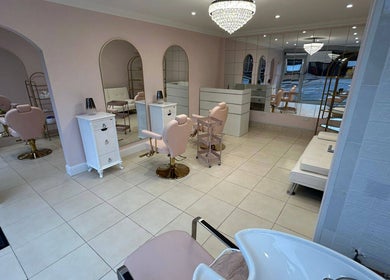 Luxurious interior of Rose Gold Hair & Beauty salon in Hounslow, England, GB, with chic decor and seating.