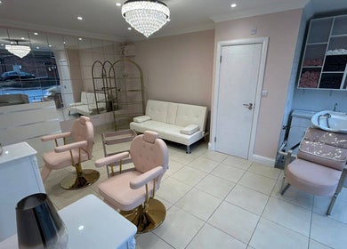 Chic interior of Rose Gold Hair & Beauty in Hounslow, England, GB with plush seating and modern decor.