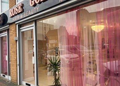 Exterior view of Rose Gold Hair & Beauty, Hounslow, England, showcasing chic glass frontage.