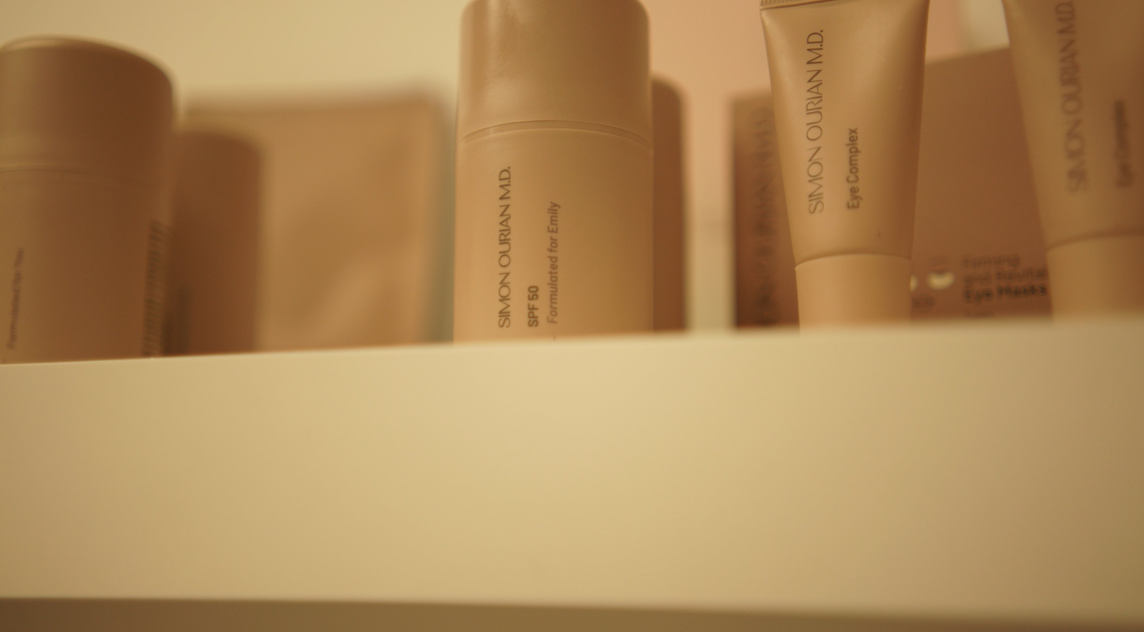 Verzorgingsproducten op plank bij Glow By Ems, Arkel, Zuid-Holland, NL voor ultieme schoonheidsverzorging.