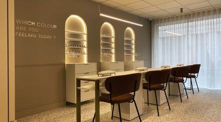 Interior do lounge NAILISH em Porto, PT, com poltronas elegantes e luz suave.