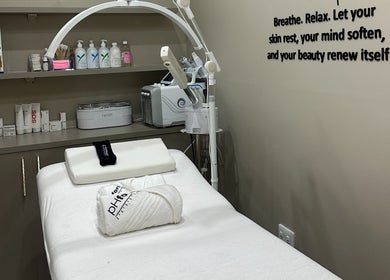 Treatment room at AL Beauty Bar in Centurion, Gauteng, ZA featuring a massage table and skincare products.