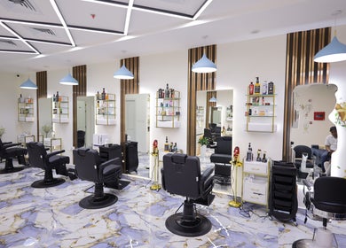 Modern interior of NU Gent's Salon in Dubai, Dubai, AE showcasing sleek styling chairs and vibrant decor.