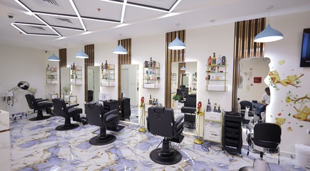 Modern interior of NU Gent's Salon in Dubai, Dubai, AE showcasing sleek styling chairs and vibrant decor.
