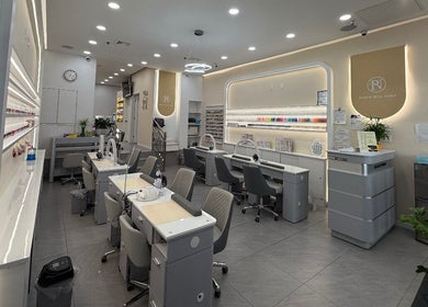 Modern interior of newpalettenailsstudio in New York, New York, US with chic nail stations and polished decor.