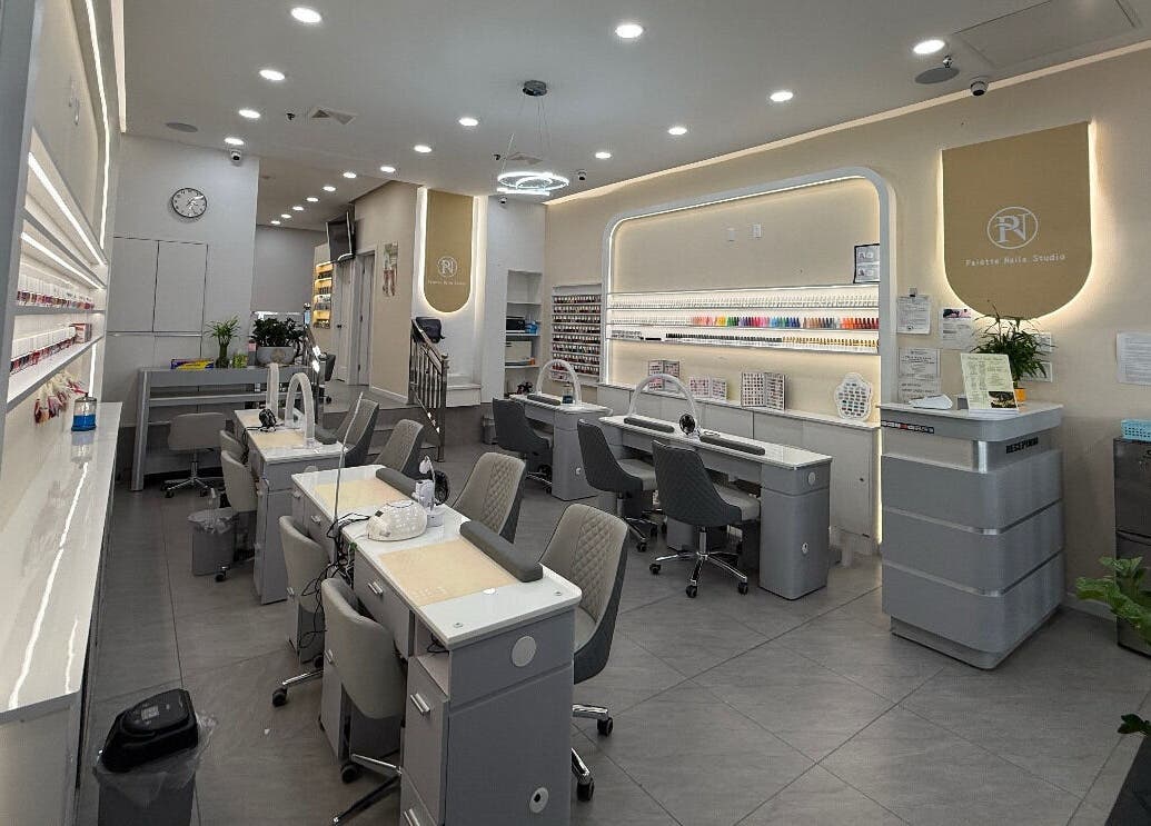 Modern interior of newpalettenailsstudio in New York, New York, US with chic nail stations and polished decor.