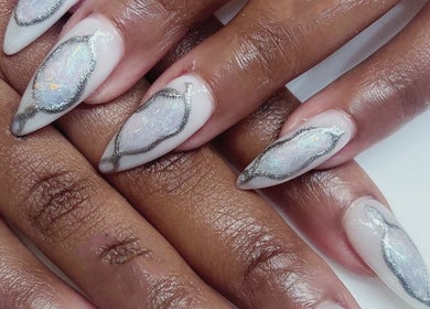 Shimmering opalescent nail design at newpalettenailsstudio, New York, New York, US. Silver and white elegance.