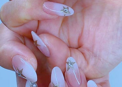 Elegant star-themed nail art at newpalettenailsstudio in New York, New York, US.