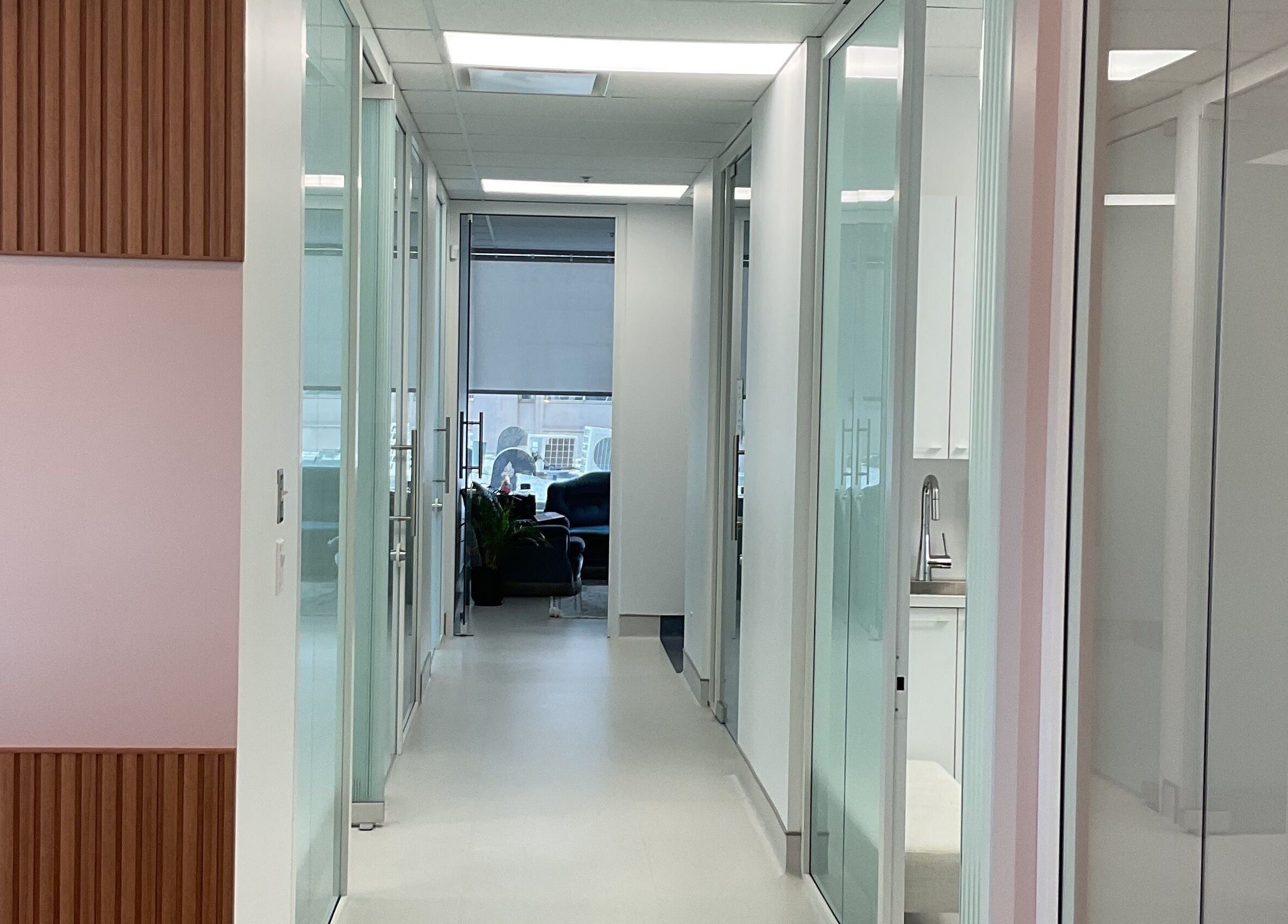 Modern hallway at Aesthetic Injector Randa in Westmount, Quebec, CA with glass doors and sleek interiors.