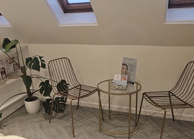 Modern seating area with plants at AuraLuxe Aesthetics, Saint Leonards, England, GB.