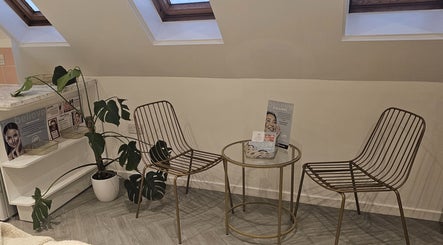 Modern seating area with plants at AuraLuxe Aesthetics, Saint Leonards, England, GB.