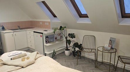 AuraLuxe Aesthetics cozy treatment room with skylights in Saint Leonards, England, GB.