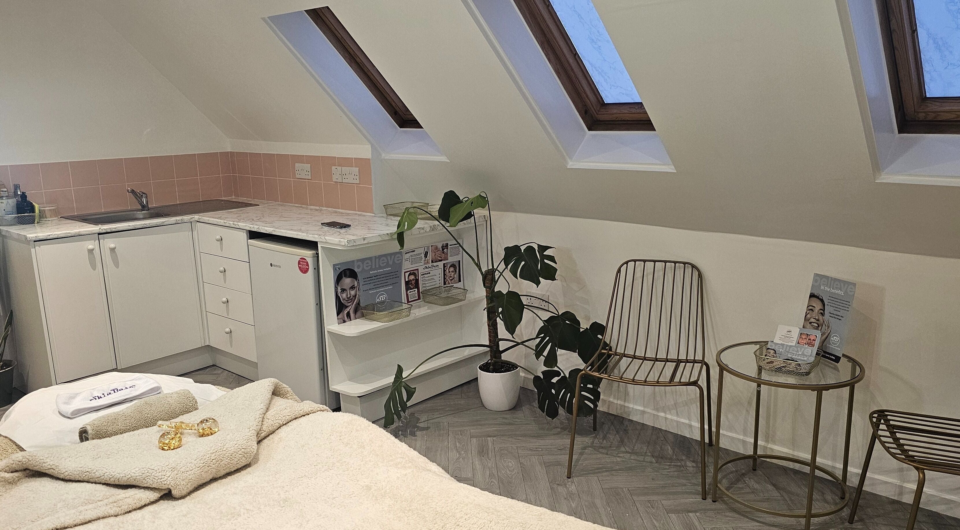 AuraLuxe Aesthetics cozy treatment room with skylights in Saint Leonards, England, GB.