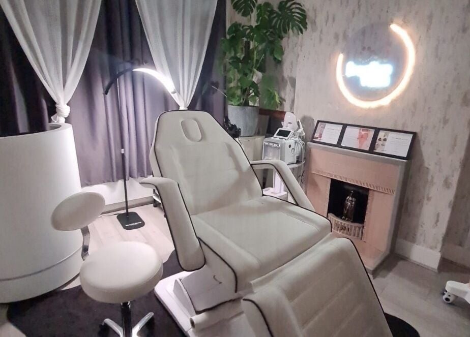 Relaxing treatment room at Medispa Naturhouse, Stevenage, England, GB, featuring a comfortable chair and calming decor.